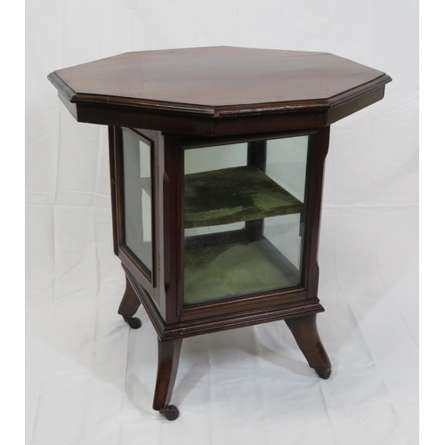 59 - Edwardian mahogany hexagonal table with glazed press under, on shaped legs with castors