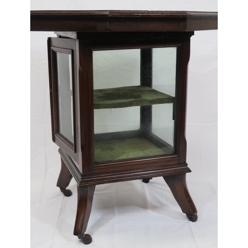 59 - Edwardian mahogany hexagonal table with glazed press under, on shaped legs with castors