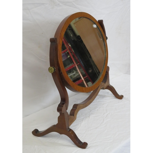 62 - Oval Edwardian mahogany swivel mirror with shaped columns and bracket feet