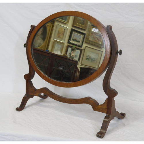 62 - Oval Edwardian mahogany swivel mirror with shaped columns and bracket feet