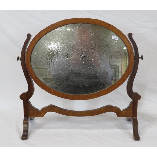 62 - Oval Edwardian mahogany swivel mirror with shaped columns and bracket feet