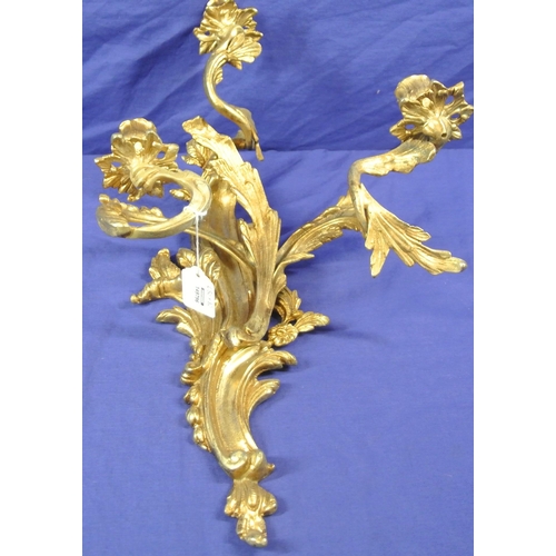 63 - Ornate brass wall bracket with shaped sconces, and foliate decoration