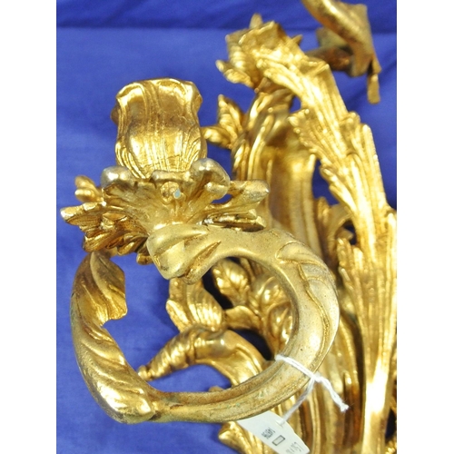 63 - Ornate brass wall bracket with shaped sconces, and foliate decoration