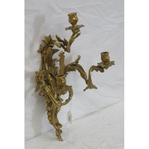 63 - Ornate brass wall bracket with shaped sconces, and foliate decoration