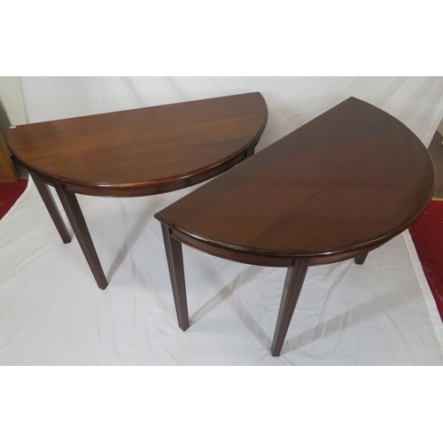 75 - Pair of Edwardian mahogany demi-lune side or alcove tables with rounded borders, raised on reeded ta... 