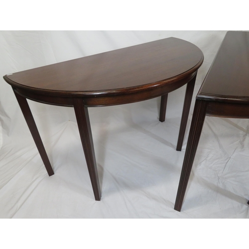 75 - Pair of Edwardian mahogany demi-lune side or alcove tables with rounded borders, raised on reeded ta... 