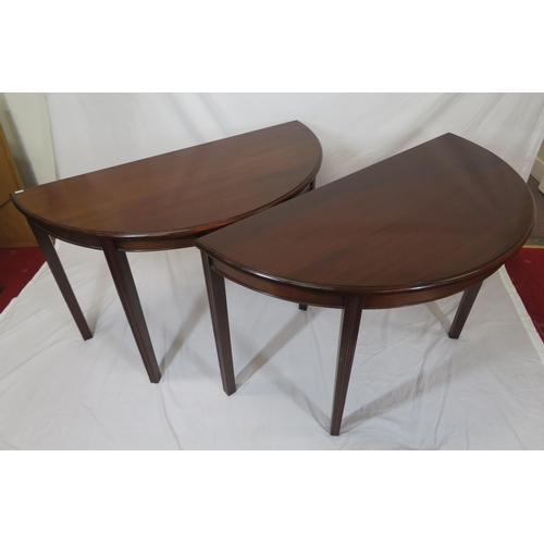 75 - Pair of Edwardian mahogany demi-lune side or alcove tables with rounded borders, raised on reeded ta... 