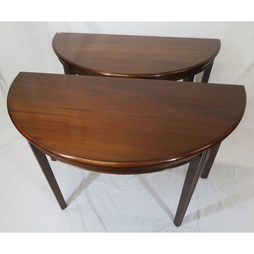 75 - Pair of Edwardian mahogany demi-lune side or alcove tables with rounded borders, raised on reeded ta... 