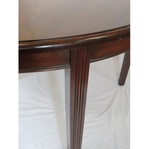 75 - Pair of Edwardian mahogany demi-lune side or alcove tables with rounded borders, raised on reeded ta... 