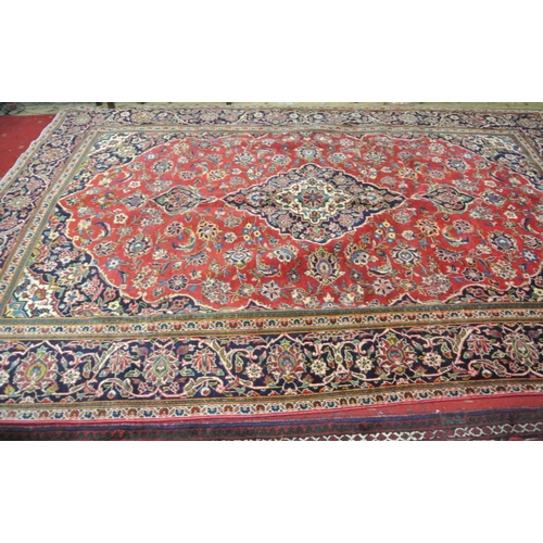 88 - Fine woven multi-coloured field Kashan carpet, red based with floral medallion design 310x210cm