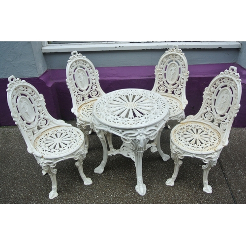 115 - Five piece cast iron garden or patio suite, round table & four chairs with figured and foliate decor... 