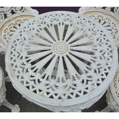 115 - Five piece cast iron garden or patio suite, round table & four chairs with figured and foliate decor... 