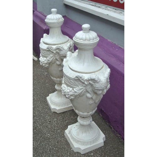 116 - Pair of Georgian style cast iron garden vases with shaped tops, ram head handles, grapevine decorate... 