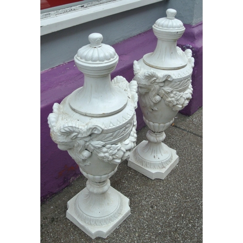 116 - Pair of Georgian style cast iron garden vases with shaped tops, ram head handles, grapevine decorate... 