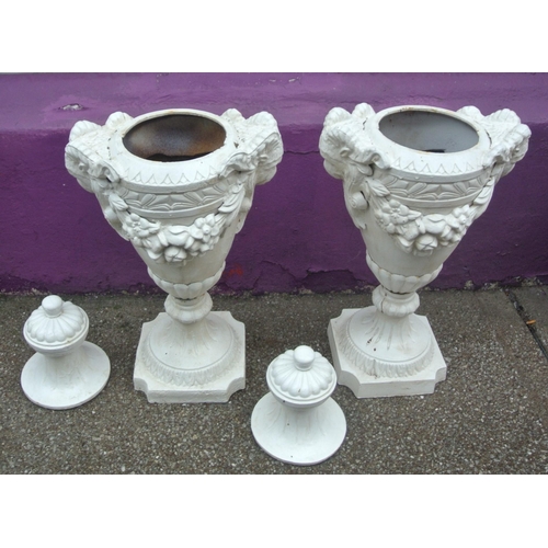 116 - Pair of Georgian style cast iron garden vases with shaped tops, ram head handles, grapevine decorate... 