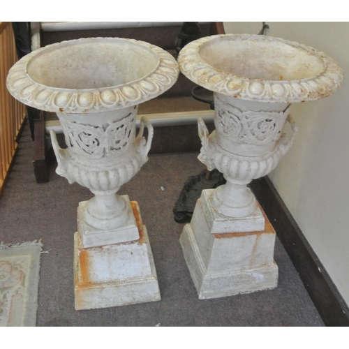 117 - Pair of Victorian style cast iron campana shaped garden vases with ribbed socles, shaped handles, sq... 