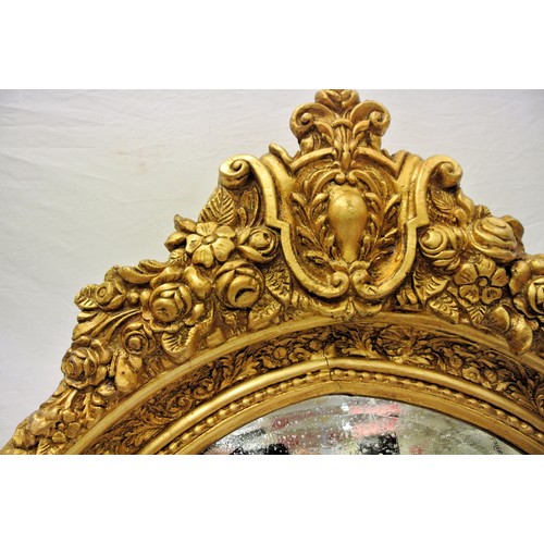 127 - Regency style oval gilt framed wall mirror with scroll & foliate pediment and ornate frame