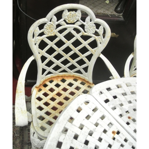 230 - Five piece cast iron garden suite, round table with pierced decoration and four armchairs with honey... 