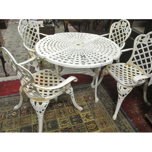 230 - Five piece cast iron garden suite, round table with pierced decoration and four armchairs with honey... 