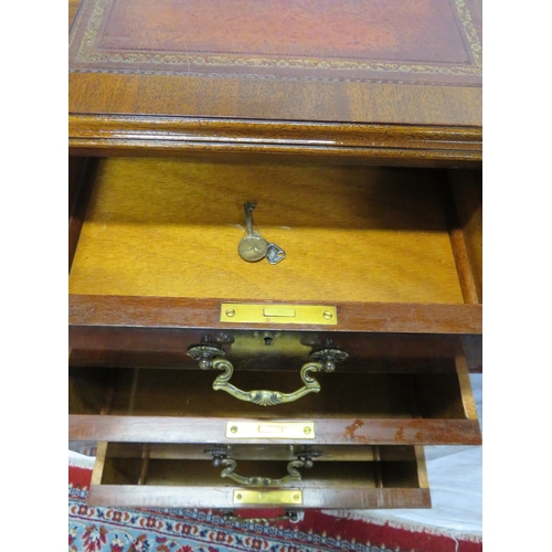 100 - Edwardian mahogany pedestal desk with seven drawers, leatherette inset, brass drop handles, on cabri... 