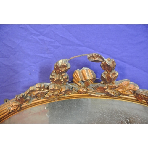 164 - Regency style oval gilt framed bevelled glass mirror with foliate decoration