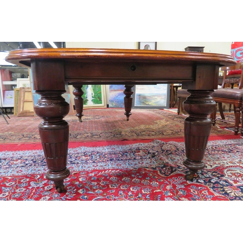 200 - Victorian mahogany extending dining table with two extra leaves inset, raised on baluster turned tap... 