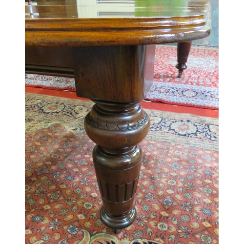 200 - Victorian mahogany extending dining table with two extra leaves inset, raised on baluster turned tap... 