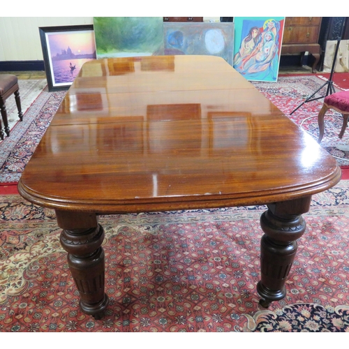 200 - Victorian mahogany extending dining table with two extra leaves inset, raised on baluster turned tap... 