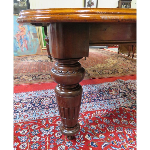 200 - Victorian mahogany extending dining table with two extra leaves inset, raised on baluster turned tap... 