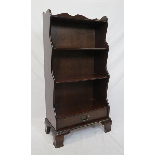 23 - Edwardian style four tier mahogany waterfall bookshelf with frieze drawer, on bracket feet