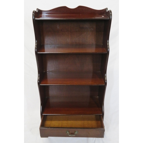 23 - Edwardian style four tier mahogany waterfall bookshelf with frieze drawer, on bracket feet