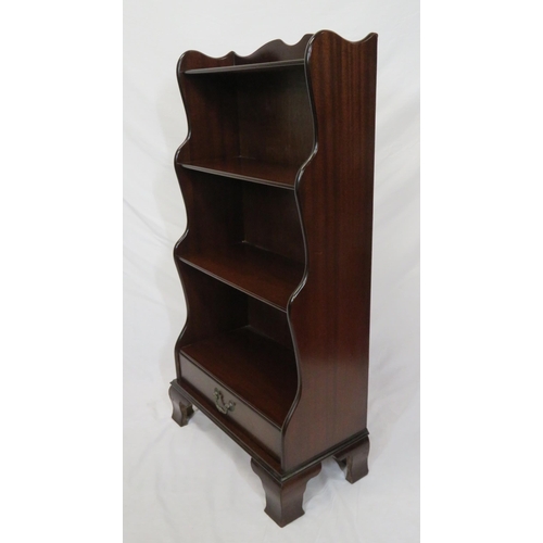 23 - Edwardian style four tier mahogany waterfall bookshelf with frieze drawer, on bracket feet