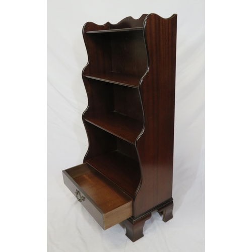 23 - Edwardian style four tier mahogany waterfall bookshelf with frieze drawer, on bracket feet