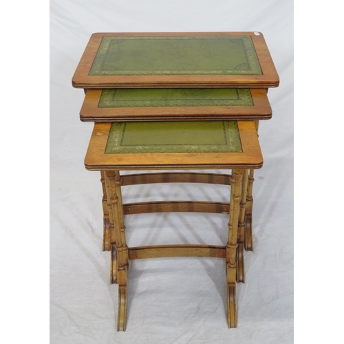 64 - Nest of three Edwardian yew tables with leatherette insets, reeded borders, turned columns & bracket... 