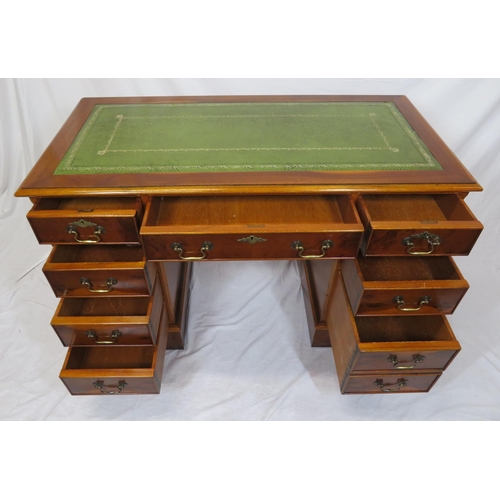 80 - Edwardian style yew pedestal desk with nine drawers, brass drop handles & escutcheons, on plinths