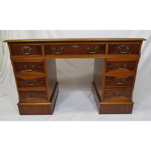 80 - Edwardian style yew pedestal desk with nine drawers, brass drop handles & escutcheons, on plinths