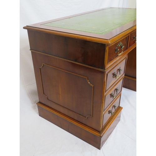 80 - Edwardian style yew pedestal desk with nine drawers, brass drop handles & escutcheons, on plinths