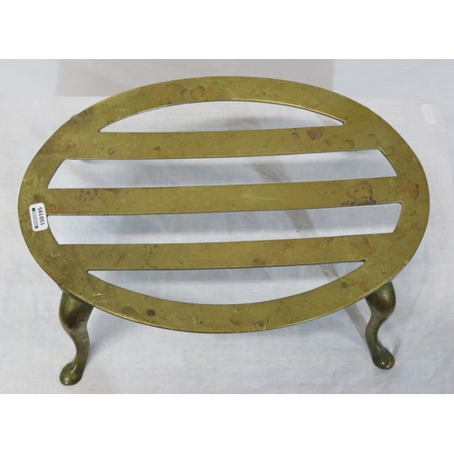 237 - Oval brass fireside trivet with railed top and shaped legs