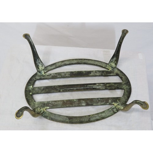 237 - Oval brass fireside trivet with railed top and shaped legs