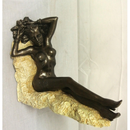 258 - Ornate bronzed ornament of a reclining nude, on shaped base