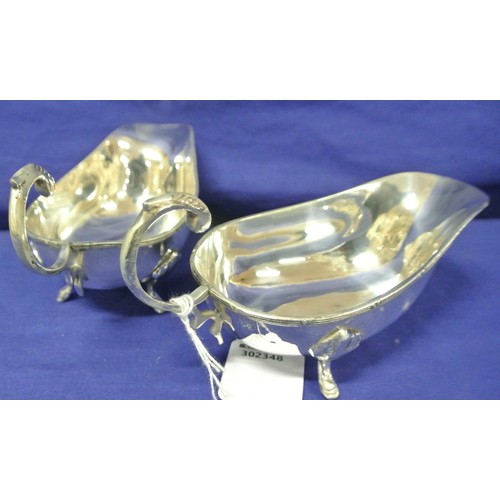 19 - Pair of boat shaped silver plated sauceboats with Celtic design rims, S-scroll handles and hoof feet