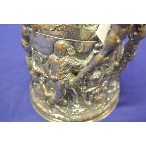 28 - Continental silver plated tankard with hinged lid, shaped handle, ornately decorated with figures, f... 