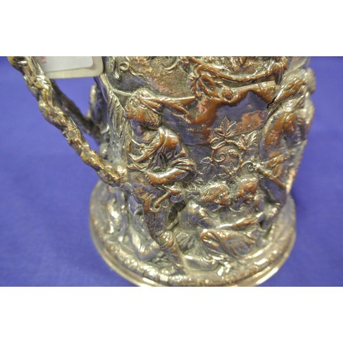 28 - Continental silver plated tankard with hinged lid, shaped handle, ornately decorated with figures, f... 