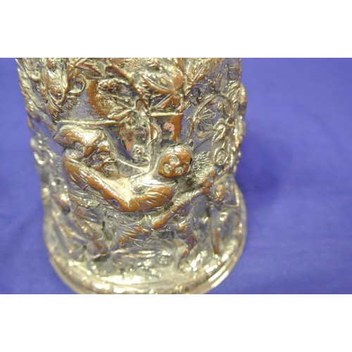 28 - Continental silver plated tankard with hinged lid, shaped handle, ornately decorated with figures, f... 