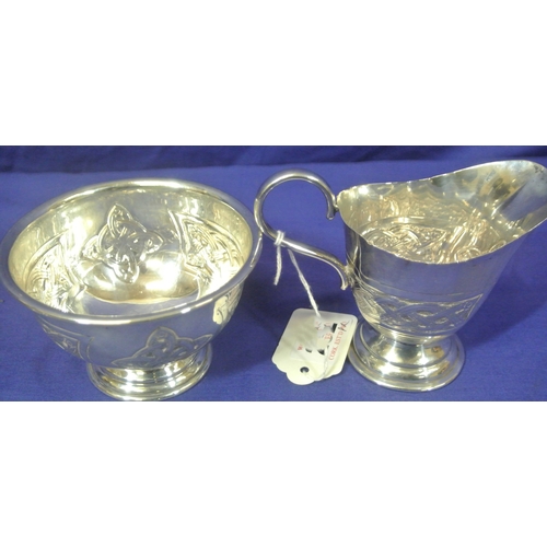 252 - Irish silver creamer and sugar bowl with Celtic decoration and spreading bases,  by Bee Moynihan & C... 