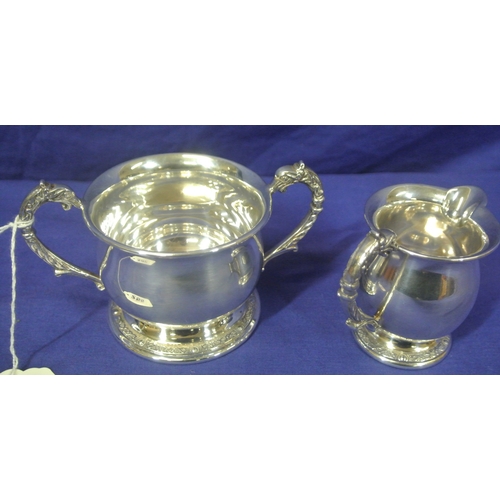 255 - Irish silver creamer and sugar bowl with shaped handles, Celtic design round bases, makers mark 'LG'... 