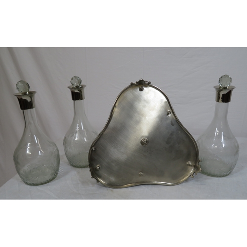 34 - Victorian silverplated tantalus with 3 glass bottles inset, on shaped base