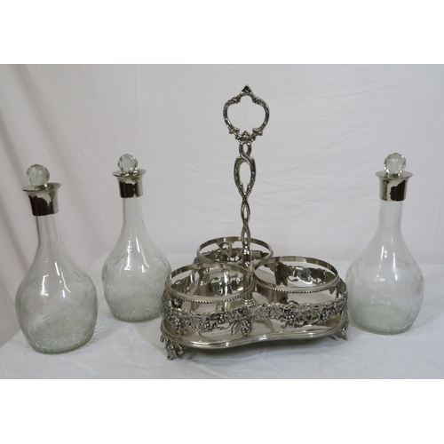 34 - Victorian silverplated tantalus with 3 glass bottles inset, on shaped base