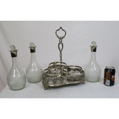 34 - Victorian silverplated tantalus with 3 glass bottles inset, on shaped base