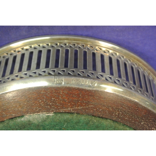 89 - London silver round wine bottle coaster with pierced decoration and timber base, dated 1984